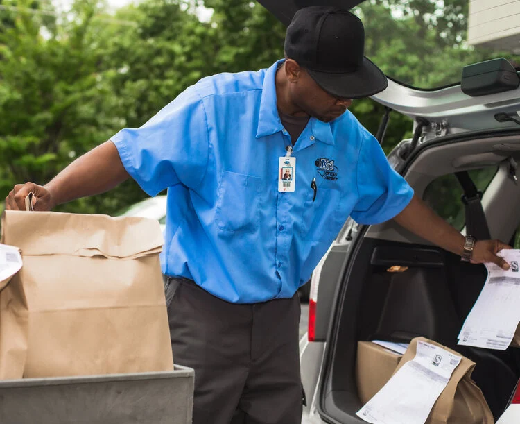 KTI Express Courier driver completing a professional delivery